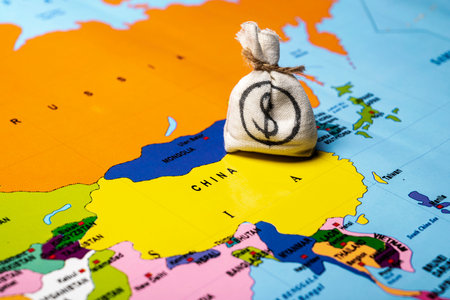 Map of China with a money bag of dollars. Concept of the United States of America versus China trade war disputes or economic conflictの写真素材