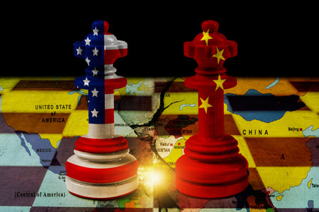 USA or United States of America and China flags painted on two chess kings with a world map on the chessboard. Concept of United States of America versus China trade war disputes or economic conflictの写真素材