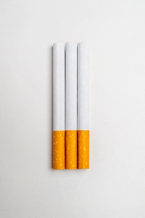 Cigarettes, rolled tobacco in paper with a filter tube, isolated on a white background. No or quit smoking, a bad habit, and unhealthyの写真素材