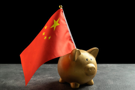 Piggybank with a China flag on a black background. Concept of economy, financial or governmentの写真素材