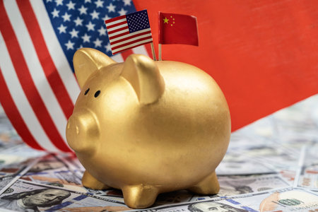 Piggybank with the USA and China flags with dollar banknotes. Concept of the United States of America versus China trade war disputes or economic conflictの写真素材