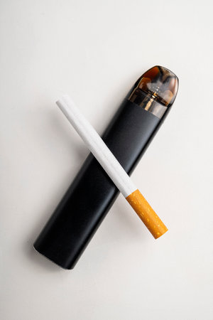 Cigarette, rolled tobacco in paper with a filter tube, and a vape or electronic cigarette are isolated on a white background. No or quit smoking, a bad habit, and unhealthyの写真素材