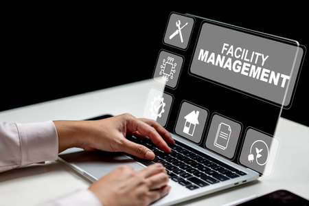 Businesswoman using a laptop and showing a facility management icon. Tablet on the table. Technology innovation on a virtual screen. Concept of facility managementの写真素材