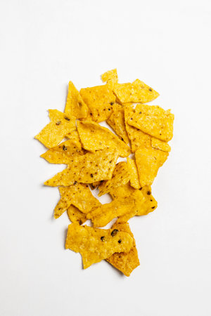 Heap of nachos tortilla chips on a white background. Food and snacks conceptの写真素材