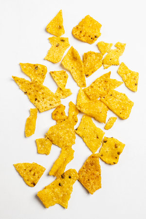 Heap of nachos tortilla chips on a white background. Food and snacks conceptの写真素材