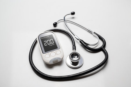 Doctor stethoscope and a glucometer with the glucose level on the screen. Concept of diabetes or a healthy lifestyleの写真素材