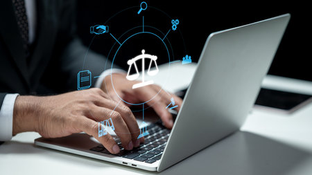 Businessman using a laptop and showing a judge scale icon. Tablet on the table. Technology innovation on a virtual screen. Concept of law, justice, legal services, and business legislationの写真素材