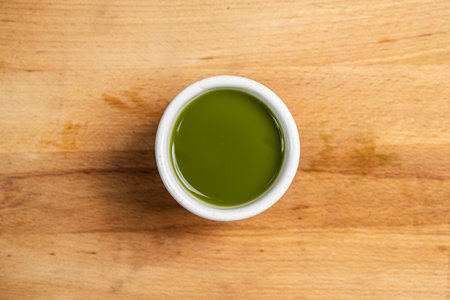 Closeup view of matcha green tea in the bowl on the table. Top viewの写真素材