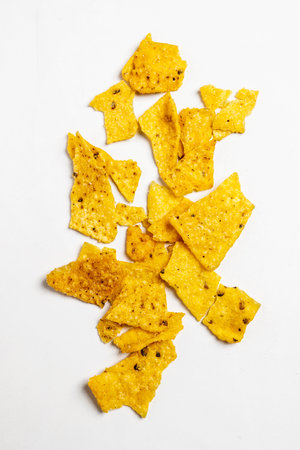 Heap of nachos tortilla chips on a white background. Food and snacks conceptの写真素材