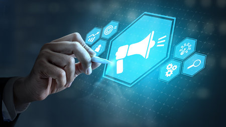 Businessman touching the icon of a megaphone. Technology innovation on a virtual screen. Concept of public relationsの写真素材