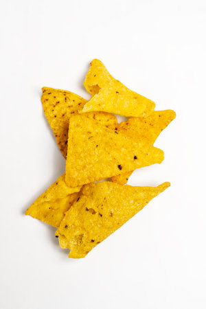 Heap of nachos tortilla chips on a white background. Food and snacks conceptの写真素材