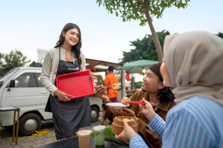 Indonesian southeast chinese asian female waiter serving food and beverage order to chinese muslim...