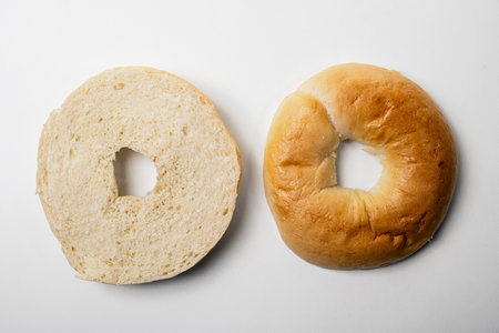 Closeup view of slice of bagel breads isolated over white background. Top and middle part. Top viewの写真素材