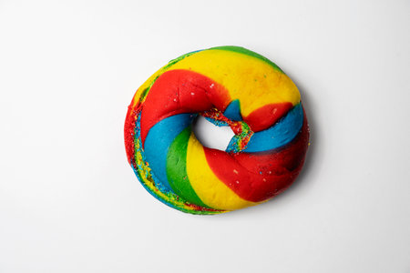 Closeup view of slice of rainbow bagel breads isolated over white background. Top viewの写真素材