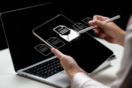 Businesswoman using a tablet with an invoice and mail icon. Laptop on the table. Technology...