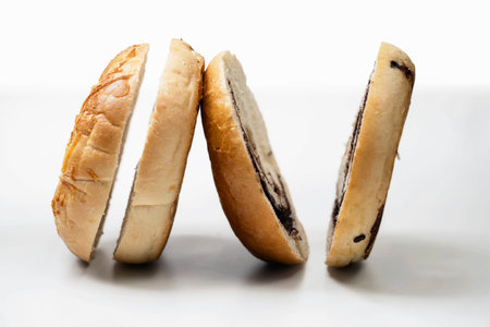 Closeup view of slices of bagel bread isolated over a white backgroundの写真素材