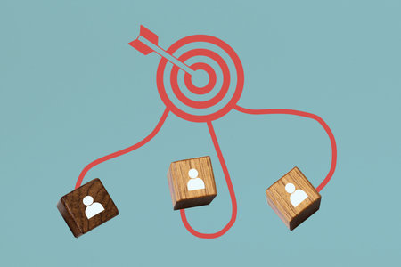 Human symbol on wooden cubes connected to a dartboard with an arrow on a colored background. Concept of planning. Collage artの写真素材