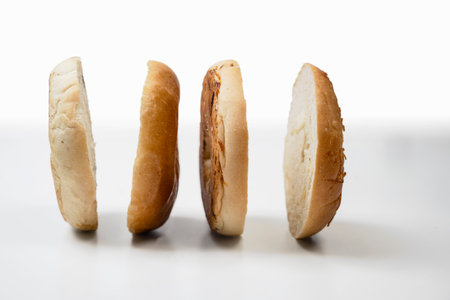 Closeup view of slices of bagel bread isolated over a white backgroundの写真素材