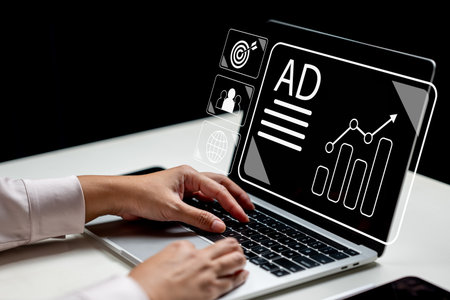 Businesswoman using a laptop with an ad icon on the screen. Technology innovation on a virtual screen. Concept of advertising and marketing plan strategiesの写真素材