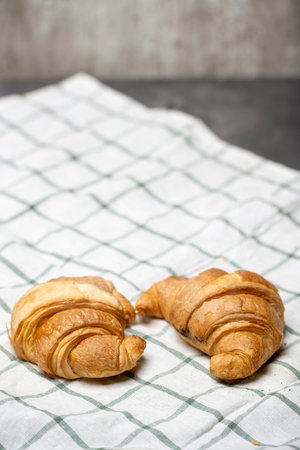 Croissants on a cloth on the table with black backgroundの写真素材