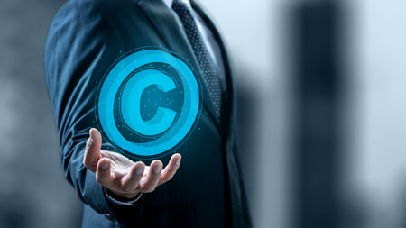 Businessman showing a copyright logo on his hand. Technology innovation on a virtual screen. Concept of digital copyright and patent, intellectual assets and property, legal protectionの写真素材