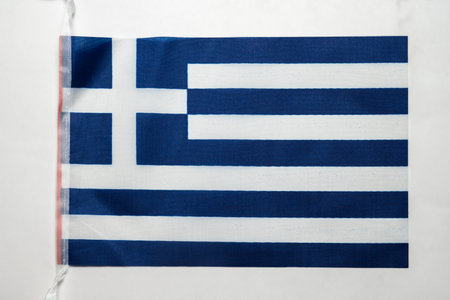 Closeup view of the Greek or Greece national flag isolated over a white background. Concept of government and nationalityの写真素材