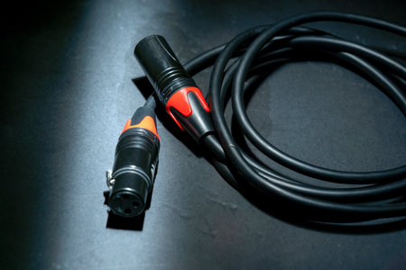 Closeup view of an audio jack cable on a black background. XLR audio cableの写真素材