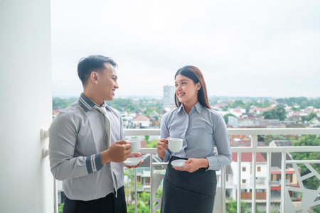 Indonesian southeast asian business people with a cup of coffee while meeting for planning, collaboration and strategy. Team collaboration and meetings conceptの写真素材