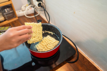 Couple of family cooking noodles together in the modern kitchen. Household routine concept
