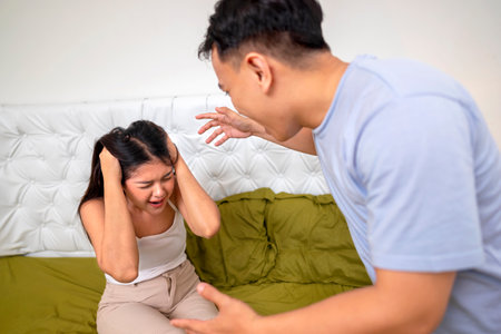 Indonesian southeast asian couple have an argument in the bedroom. Having a crisis and difficulties in a relationshipの写真素材