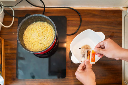 Couple of family cooking noodles together in the modern kitchen. Household routine conceptの写真素材