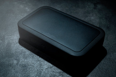 Box of clip on wireless microphone for interview or podcast equipment on a black backgroundの写真素材