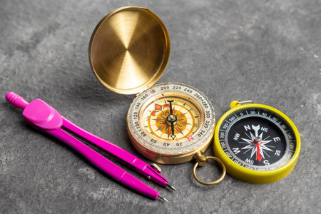 Closeup view of navigational compass and pink compasses. Travel guidance equipmentの写真素材