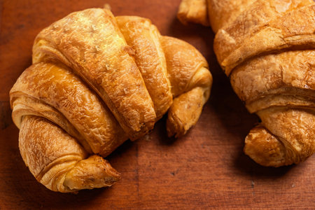 Freshly baked croissants on a wooden background. Top viewの写真素材