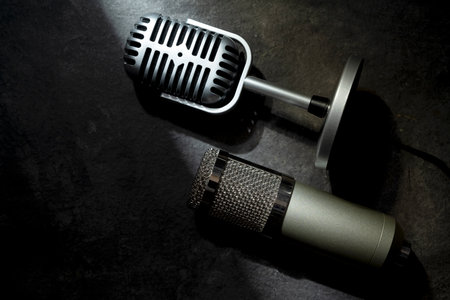 Studio and vintage silver microphone for podcasting or streaming with a black background. Top viewの写真素材