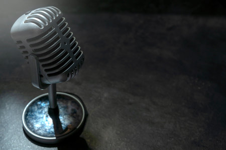 Vintage silver microphone with a black backgroundの写真素材