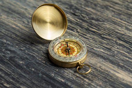Closeup view of navigational compass on wooden background. Travel guidance equipmentの写真素材