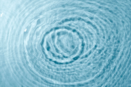 Blue water texture background. Clean transparent water surface with rings and ripples. Summer concept. Flat layの写真素材