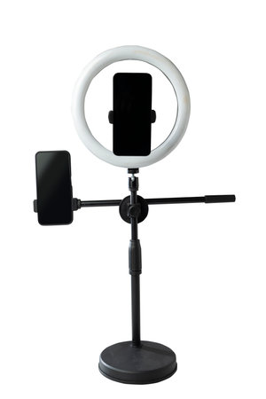 Round LED ring light with a cellphone on a phone holder isolated over a white background. Vlogging...