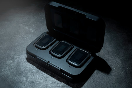 Clip on wireless microphone for interview or podcast equipment in the box on a black backgroundの写真素材