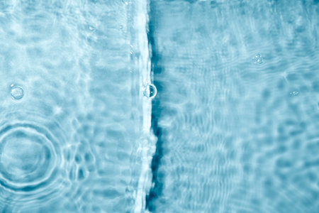 Blue water texture background. Clean transparent water surface with rings and ripples. Summer...