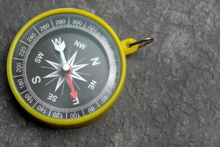 Closeup view of navigational compass on black background. Travel guidance equipmentの写真素材