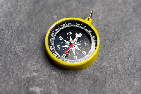 Closeup view of navigational compass on black background. Travel guidance equipmentの写真素材