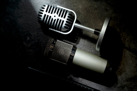 Set of Studio and vintage silver microphones for podcasting or streaming with a black background. Top viewの写真素材