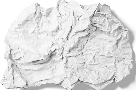 Crumpled sheet of white paper isolated on a white background. Creased and wrinkled paper surface....