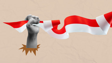 Human hand holding the Indonesian ribbon flag to celebrate Indonesia Independence Day. Collage art. Concept of Kemerdekaanの写真素材