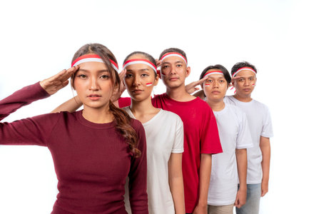 Indonesian southeast asian people celebrating Indonesia Independence Day on the 17th of August with a respectful attitude isolated over a white background. Concept of Kemerdekaan Indonesiaの写真素材