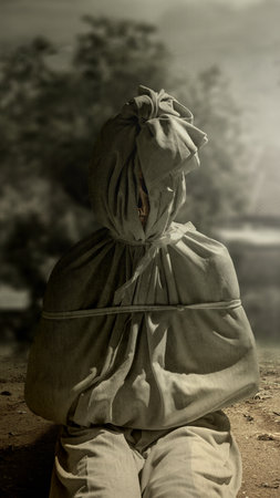 Pocong on the field at night. A traditional ghost from Indonesia that takes the form of a human wrapped in a shroud or winding sheet. Concept of Halloweenの写真素材