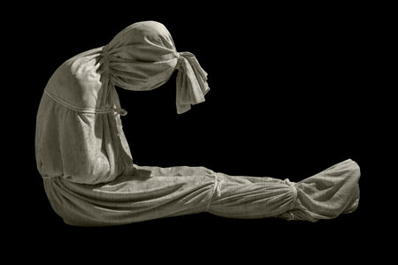 Pocongs on a black background. A traditional ghost from Indonesia that takes the form of a human wrapped in a shroud or winding sheet. Concept of Halloweenの写真素材