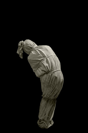 Pocongs on a black background. A traditional ghost from Indonesia that takes the form of a human wrapped in a shroud or winding sheet. Concept of Halloweenの写真素材